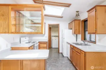 Skylight and pristine cabinetry adorn the kitchen