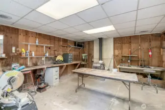 Shop houses work benches, with power, running water and woodstove.
