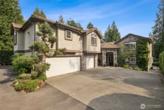 The main house is the one closer to the river and the apartment is above the 3-car garage on the left.