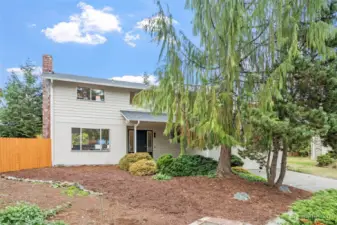 This two-story home features a 2022 roof update and fresh exterior paint for a clean, modern look. Mature landscaping adds privacy and character to the front yard.