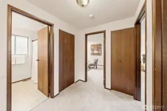 The upper-level hallway guides you to the additional bedrooms, a full guest bathroom, and the secluded Primary Suite tucked at the end—offering a functional layout that balances shared and private spaces   beautifully.