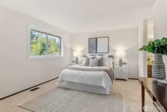 Welcome to the Primary Suite! You've found the perfect place to come and unwind! The large picture window frames the back garden and allows ample natural light in when you want it. Notice the wood wrapped window for extra detail.