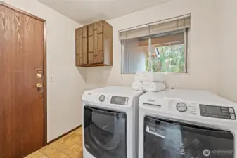 The utility room is conveniently located off the garage for easy access after outdoor activities. Generous space allows for organized laundry and household storage.