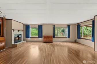 Great room with natural light and fireplace.
