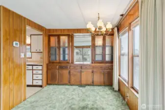 Here is the dining room just off with the kitchen, also with large windows.
