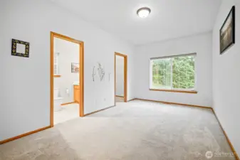 Spacious primary bedroom has attached full bath and walk in closet.