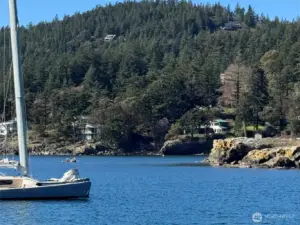 This photo was taken across Eastsound Bay looking towards the property from the County public dock. The property enjoys a mooring buoy in front of the house, seen across the bay (white ball). Protected Indian Island sits proudly to right, accessed on foot at low tide.