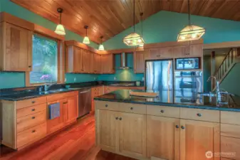 A cook's delight!!! This kitchen boasts custom cabinetry, vaulted ceiling and plenty of counter space for whatever you intend to create in this dream space.