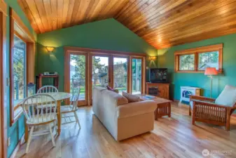 Main living space is cozy year round with propane stove keeping the chill off the winter mornings. You see main home out the windows. Waterside deck off the french glass doors.