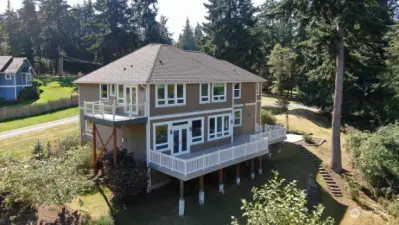 Northeast corner of the house. Great view of the expansive deck & Primary Suite balcony.