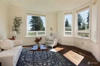 The Sitting Room which has views of the Sound & Cascades, the apple trees & one of the rose bushes. French doors provide privacy while maintaining the flow of light that pours through all the windows.