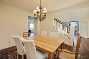 Looking back at the foyer to the right and towards the living room to the left.  You will appreciate the refinished walnut floors, generous window placement and ceiling height in this home.