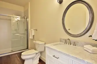 3/4 Main level bath with newly installed shower. Marble countertops.