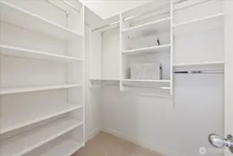 Closet system in the walk-in closet provides for efficient storage options.
