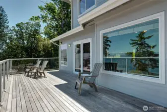 Large 10' x 28' deck with glass railings has gorgeous water views & mountain views of snow capped Mt Baker & the Cascades. Also wonderful for entertaining, whale watching or relaxing.