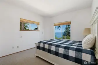 Main floor bedroom is large, bright & has an amazing water & mountain view.