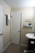 Gain access to the bathroom from the main hallway or the bedroom