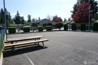 Fully fenced athletic court with picnic table