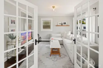 There are French doors into this family/bedroom from the living room as well as a regular door from the hallway.