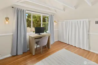 The built-in twin bed space on this side of the room is being used as a 3rd closet in this room.