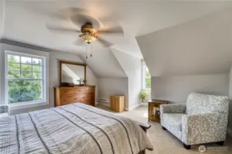 The upstairs primary suite, it is a first-class retreat.