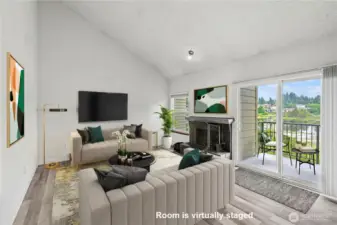 Bright living room with cathedral ceilings & view of the Lake