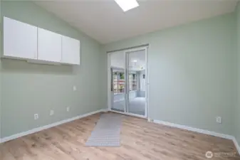 Bonus room, sliding doors lead to an enclosed porch