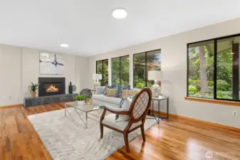 Rich hardwoods in Living Room, newly refinished! Gather at the gas fireplace!