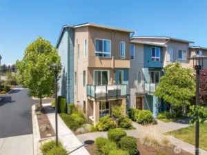 Premium corner unit with quiet street entry, lush landscaping, and direct access to private park.