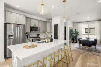 Bright kitchen with large island, open to dining
