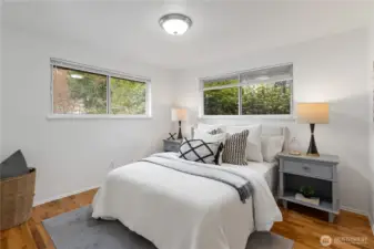 Down the hallway is Bedroom #1 with dual vinyl windows, new blinds, refinished oak hardwood flooring and fresh interior paint.