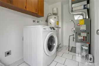 Past the kitchen is the mudroom with convenient built-in shelving for additional storage, ceramic tiled flooring and a side door for easy backyard and driveway access.