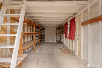 The oversized storage shed comes with convenient power, shelving and a ladder to the overhead storage unit.