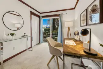 Entry floor bedroom, staged as an office. This room has direct access to the private patio.