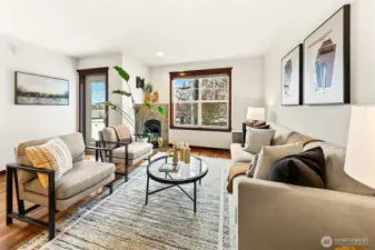 Living room has windows to the south and west for great natural light. Cozy gas fireplace anchors the space.
