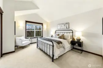 Primary bedroom with west views and vaulted ceilings.