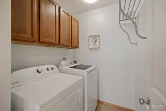 2nd floor laundry room with cabinets and clothes drying rack. Appliances stay and so does the drying rack.