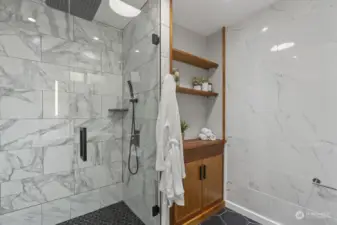 Smart built-ins, cool hex tile floors, dual vanities, and a sleek glass shower!