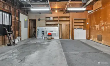 Garage with laundry and a shop behind garage.