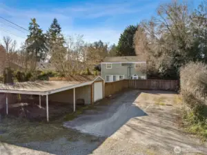 View of parking area, carport and single car garage.