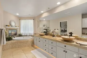 The 5-piece ensuite bath feels like a private spa, complete with dual vanities, a soaking tub, walk-in shower, and a spacious walk-in closet.