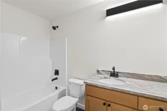 Main floor bath with gorgeous cabinetry & counter. Mirror to be installed prior to Closing.