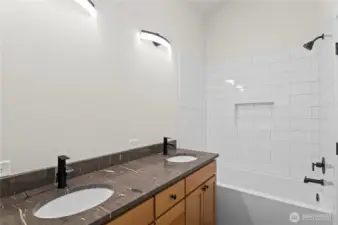 Double sink vanity with plenty of storage, stunning tile work and soaking tub.  Mirror to be installed prior to closing.
