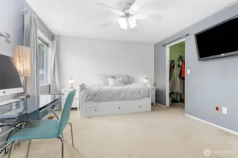 Upper level primary suite with walk-in closet and 3/4 bathroom.