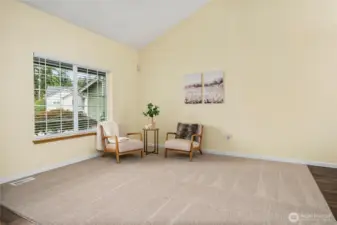 A closer look at the oversized front window emphasizes the amount of light this room receives. The clean wall lines and spacious layout make it easy to envision multiple furniture arrangements.