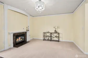 A closer view of the family room shows off the fireplace detail and generous wall space, ideal for entertainment or display. The updated ceiling fixture adds a touch of elegance.