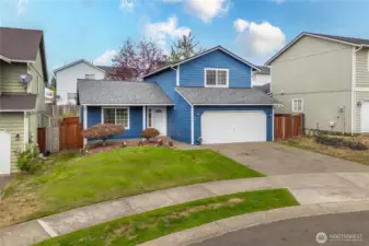 Set on a cul-de-sac, the home’s exterior combines charm and practicality, with a spacious driveway, tidy landscaping, and fully fenced side yard access.
