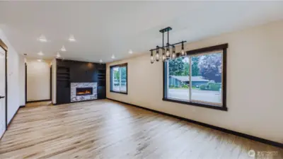 Great room with gas fireplace opens to dining area