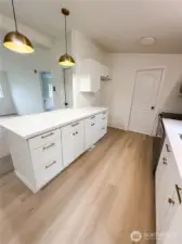Kitchen leading to pantry and washer/dryer
