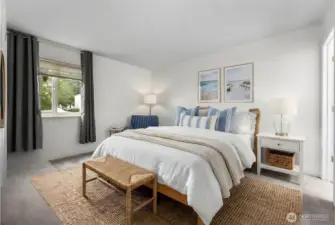 Main bedroom features brand-new carpet, fresh white paint, walk-in closet, & additional access door to the bathroom. Virtual staging to showcase potential furniture placement.